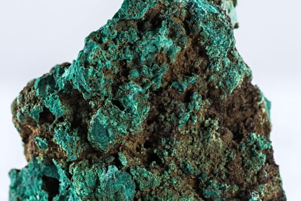 A vertical shot of a malachite mineral isolated on a white background